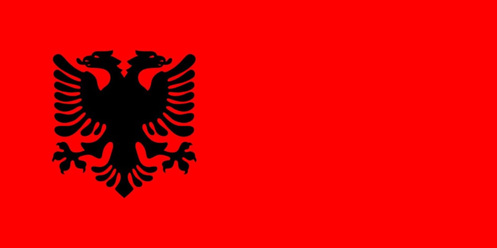 Flamuri i Republikës së Kosovës i përdorur nga 1991 deri 1999 — sfond i kuq me shqiponjën dykrenare të zezë